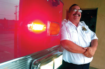 New Gallup Fire Chief Johnny Greene leans on a fire engine for a portrait in Gallup on Thursday. Greene steps in after the Gallup Fire Department has beenb without a chief ince December. &copy; 2011 Gallup Independent / Adron Gardner 
